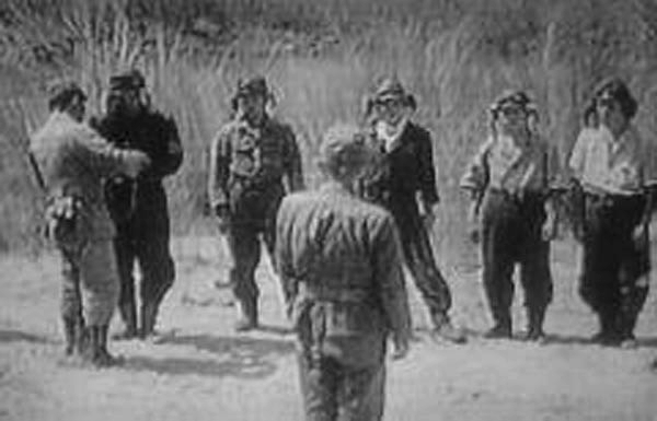 Yukio Seki receiving ceremonial water from his commanding officer Captain Asaiki Tamai before Seki's special attack mission, Mabalacat Airfield, Philippines, 25 Oct 1944, photo 1 of 2; note Vice Admiral Takijiro Onishi overseeing the ceremony