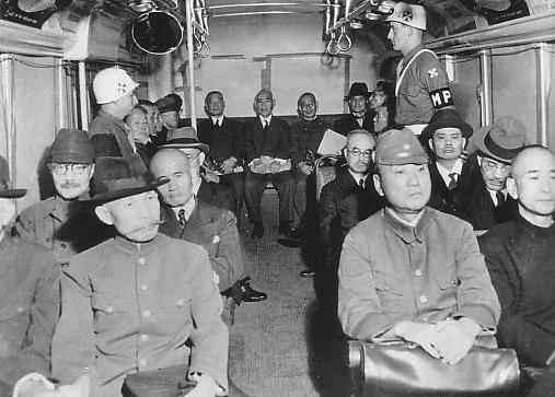 Japanese Class-A War Criminals Sadao Araki (front row), Kenryo Sato (front row), Hideki Tojo (second row), Kuniaki Koiso (rear row), Osami Nagano (rear row), and others being transported in a bus, Tokyo, Japan, 3 May 1946