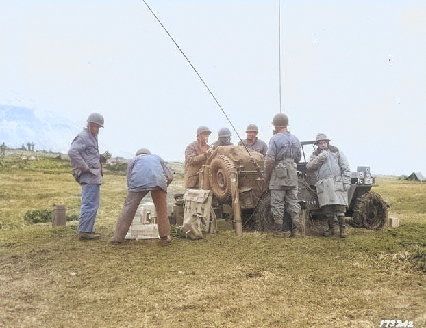 A Jeep loaded with radio and telephone equipment being used as a forward command post for a US Army artillery division, Territory of Alaska, 1943 [Colorized by WW2DB]