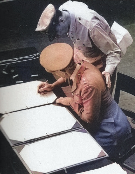 Colonel Lawrence Cosgrave signing the surrender instrument on behalf of the Dominion of Canada aboard USS Missouri, Tokyo Bay, Japan, 2 Sep 1945. [Colorized by WW2DB]