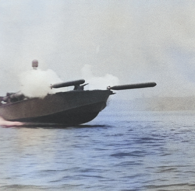 Elco 80-foot motor torpedo boat simultaneously launching two practice torpedoes during a training exercise in United States waters, 1942-44. [Colorized by WW2DB]