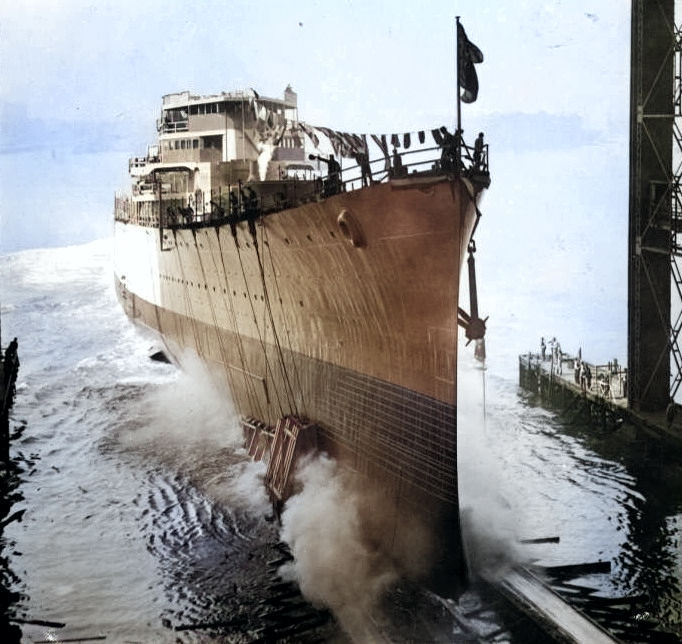 The cruiser Nashville began slipping down the ways after several nervous, motionless moments following christening at the New York Shipbuilding Corporation in Camden, New Jersey, United States, 2 Oct 1937. [Colorized by WW2DB]