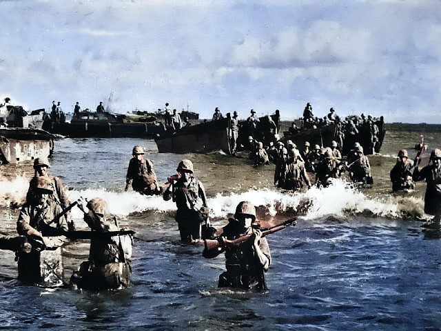 US Marines wading toward Tinian from amphibious tractors and landing boats, Mariana Islands, 25 Jul 1944, photo 3 of 3 [Colorized by WW2DB]