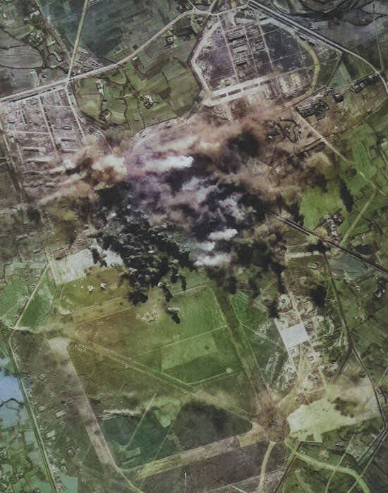 Shinchiku Airfield under B-29 attack, northern Taiwan, 17 Jan 1945, photo 3 of 3 [Colorized by WW2DB]