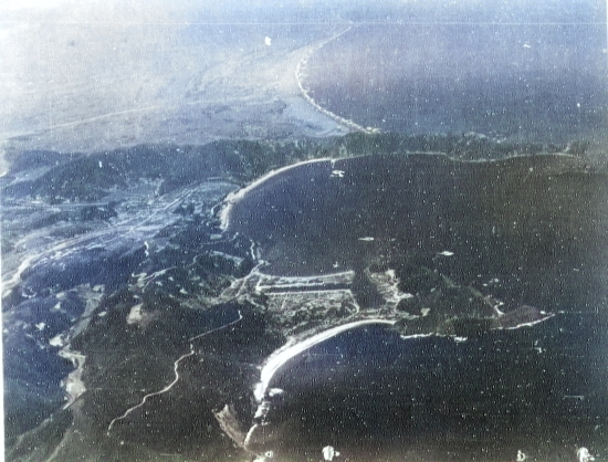 Suo (now Suao) harbor under attack by a PB4Y-1 aircraft of US Navy squadron VPB-104, eastern Taiwan, 22 Apr 1945, photo 2 of 4 [Colorized by WW2DB]