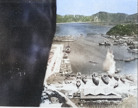 Suo (now Suao) harbor under attack by a PB4Y-1 aircraft of US Navy squadron VPB-104, eastern Taiwan, 22 Apr 1945, photo 4 of 4 [Colorized by WW2DB]