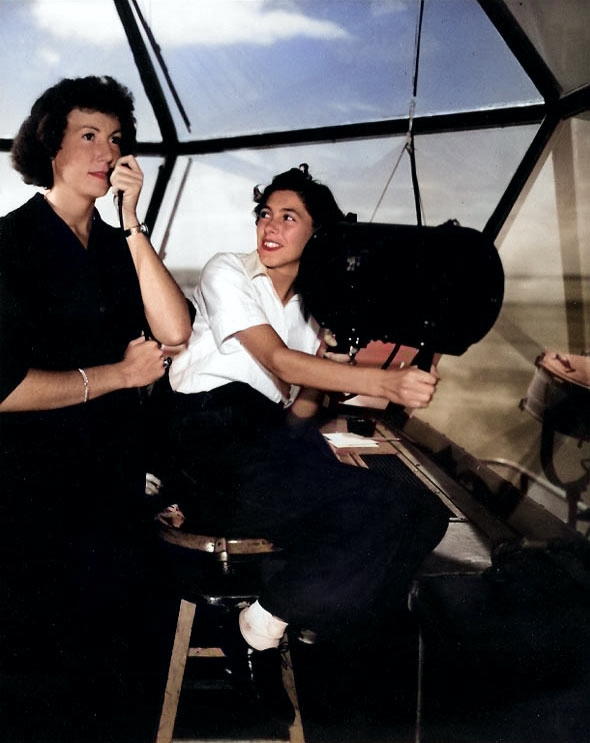 WAVES Specialist 2nd Class Mary E. Johnson directing an incoming aircraft with a microphone as Specialist 2nd Class Lois Stoneburg operated the signal lamp, Hawaiian Islands, circa mid-1945 [Colorized by WW2DB]