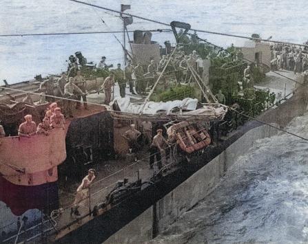 Appendicitis patient Seaman 1st Class J. R. Morris being transported from destroyer USS Grady to carrier USS Anzio for treatment, Pacific Ocean, 24 Jan 1945 [Colorized by WW2DB]