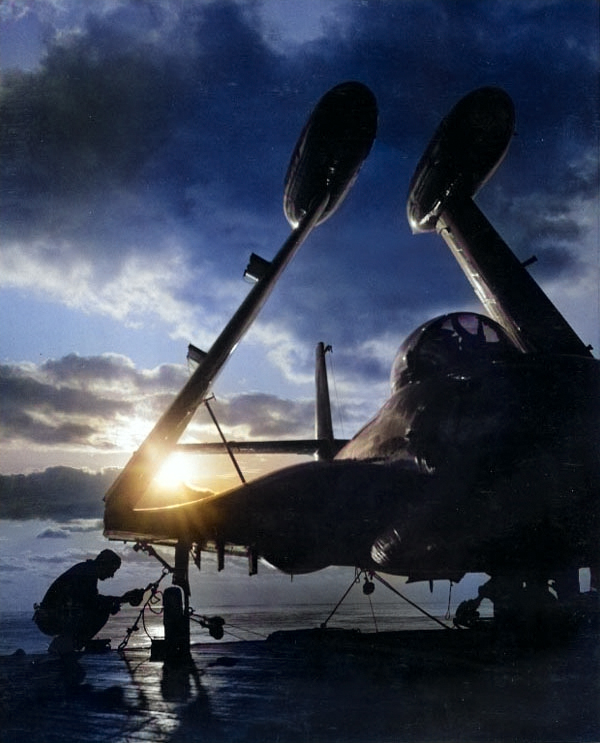 An airman of Essex lashed a F2H Banshee fighter to the flight deck, off Korea, 8 Mar 1952 [Colorized by WW2DB]