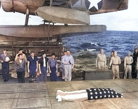 Funeral service on the fantail of the USS Honolulu on 7 Jul 1943 for F1c Irvin Edwards, a USS Helena crewman who died of his wounds. RAdm Walden Ainsworth stands with other Helena crewmen. Photo 2 of 2. [Colorized by WW2DB]