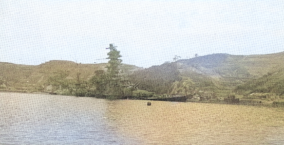 Battleship Ise sunken in shallow water near Kure, Japan, 1945-1946; seen in US Navy publication [Colorized by WW2DB]