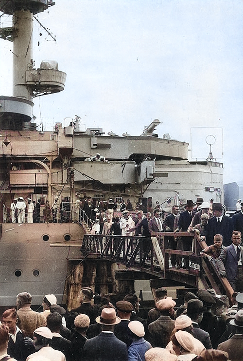 Königsberg's forward superstructure, with visitors on the gangway and on shore in the foreground during an open house at a European port, circa 1930 [Colorized by WW2DB]