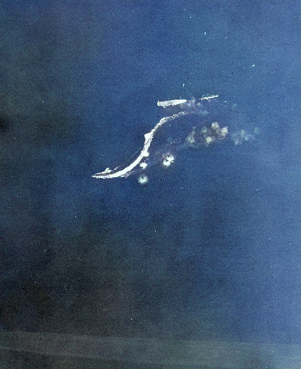 View from a USAAF B-17 bomber of Japanese destroyers Amatsukaze (bottom, sailing at speed) and Tokitsukaze (right, slowly backing away from the carrier) evacuating crew of the disabled carrier Ryujo (center, immobile), Battle of the Eastern Solomons, 24 Aug 1942, photo 3 of 3 [Colorized by WW2DB]