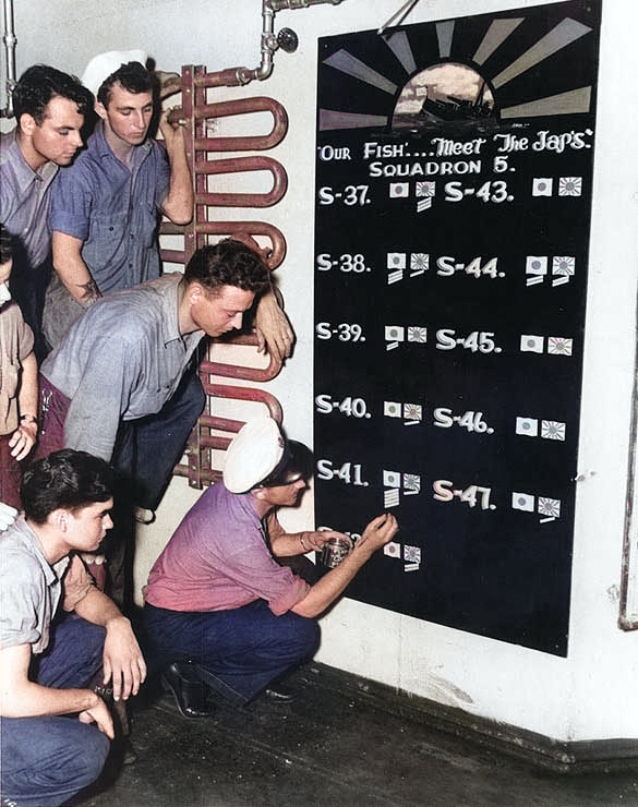 Men of US Navy Submarine Squadron 5 keeping score of sinkings aboard USS Griffin, 7 Jan 1943; the squadron operated out of Brisbane, Australia [Colorized by WW2DB]