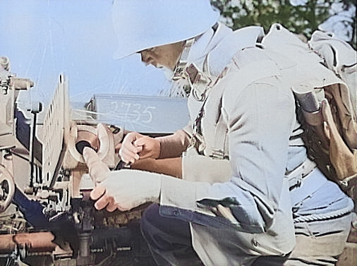 Loading a shell into a 37 mm Gun M3 during a training exercise, Fort Benning, Georgia, United States, Apr 1942 [Colorized by WW2DB]