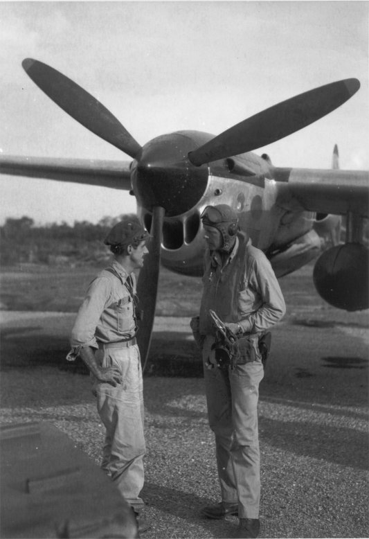 USAAF pilots Thomas McGuire and Charles Lindbergh after returning from a combat mission, at Biak Island off New Guinea, circa Jul 1944; note P-38 Lightning aircraft, possibly McGuire's, in background