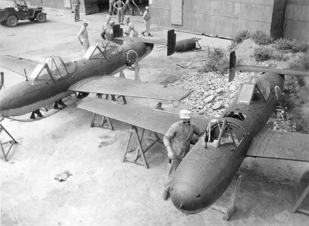 US Navy personnel inspecting MXY7 K-1 Kai training aircraft, Yokosuka, Japan, date unknown