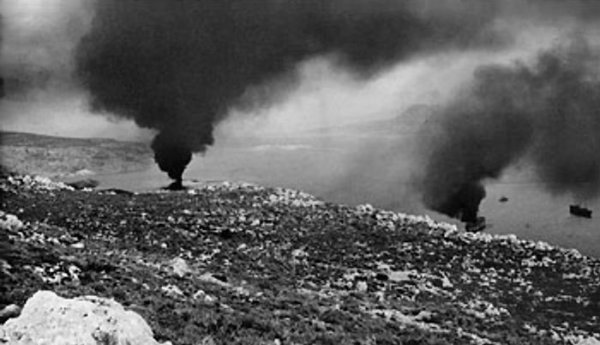 A pall of smoke hanging over the habor in Souda Bay, Crete, Greece where two ships, hit by German bombs, were burning, 25 Jun 1941, photo 2 of 2