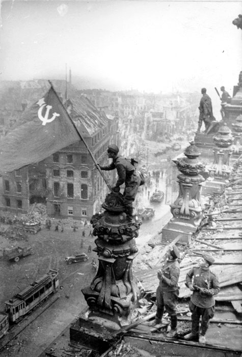 Red Army soldier Mikhail Alekseevich Yegorov of Soviet 756 Rifle Regiment flying the Soviet flag over the Reichstag, Berlin, Germany, 2 May 1945, photo 2 of 3