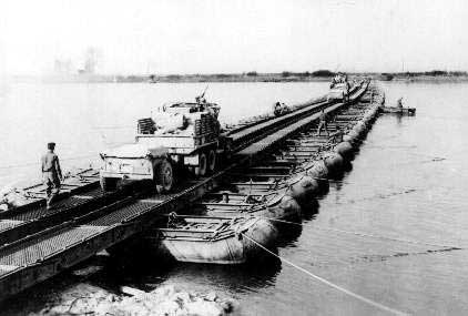 A truck crossing the Rhine River in Germany, 23 Mar 1945; this was the second bridge built by US 150th Combat Engineer Battalion