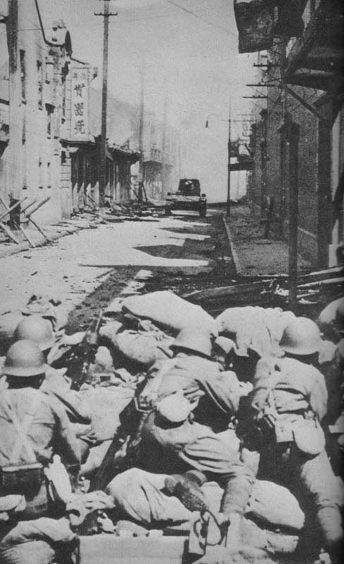 Troops of Japanese Shanghai Special Naval Landing Force fighting near Yangshupu Creek, Shanghai, China, 22 Aug 1937