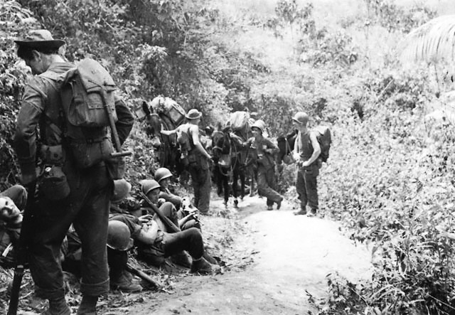 Men of the US Army 5307th Composite Unit (Provisional) 'Merrill's Marauders' resting outside of Nhpum Ga in northern Burma, circa late Mar or early Apr 1944