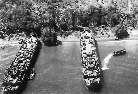 American transports unloading supplies for US 24th Infantry Division, Red Beach 2, Tanahmerah Bay, Dutch New Guinea, Dutch East Indies, 22 Apr 1944