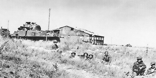 Troops of the Queen's Own Rifles of Canada regiment dug in near Carpiquet, Normandy, France with support from a M4 Sherman tank, 6 Jun 1944