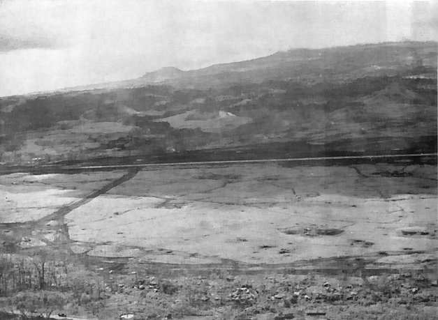 Aerial view of Airstrip No. 2 at Cape Gloucester, looking southeast, New Britain, Bismarck Archipelago, 1940s; note Razorback Ridge in background to the right