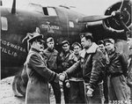 BGen Westside T Larson, CO of Antisub Command in England, commends Capt Jack H Shaw, Navigator of B-24D Liberator “Tidewater Tillie,” at RAF St Eval, Cornwall, England after the aircraft sank a German U-Boat in the Bay of Biscay.