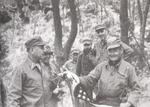 Marine Commandant Clifton Cates (left) receives the first flag flown over the recaptured Seoul, South Korea from 1st Marine Commander Col Chesty Puller, Oct 3 1950.