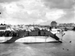 Men of Canadian 9th Infantry Brigade disembarking from LCI(L) landing craft onto Nan White Beach near Bernières-sur-Mer, Juno Beach, Normandy, France, late morning 6 Jun 1944.  Photo 2 of 2.