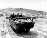 Supreme Allied Commander Dwight Eisenhower touring the Normandy invasion beaches with General George Marshall, Admiral Ernest King, and staff at St Laurent sur Mer, Jun 12 1944.  Photo 1 of 3.