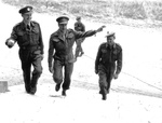 Canadian officers enter Château de Rots, Normandy, France. Left to right they are Colonel Richard S Malone, Lt General Henry Crerar (Commander, 1st Canadian Army) and Major Austin.