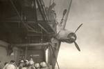 A TBF-1 Avenger hanging precariously over the side of the training aircraft carrier USS Sable on Lake Michigan, United States, 1944-45.