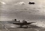 A TBM-1C Avenger after landing aboard the training aircraft carrier USS Sable on Lake Michigan, United States, as another circles around, 1944-45.