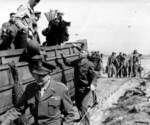 Gen Dwight Eisenhower, Gen George Marshall, and Gen “Hap” Arnold, beside their VIP DUKW during their tour of the Normandy beachhead, Normandy, France, Jun 12, 1944.