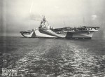 Starboard side view of Essex-class carrier Ticonderoga being delivered to the US Navy on the morning of her commissioning, Hampton Roads, Virginia, Untied States, May 8, 1944.