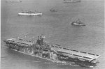 USS Ticonderoga arriving at Tacoma, Washington, United States as part of Operation Magic Carpet, Oct 27, 1945. Note the deck numbers already repainted in peace-time white & balloons supporting the Homeward Bound Pennant