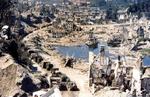 US Army convoy making its way through the devastated ruins of St. Lô, France, Aug 1944