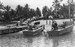 A tractor pulling an SBD Dauntless dive-bomber from a pier on Espiritu Santo, New Hebrides, mid-1942. Note LCVPs.