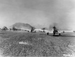 North American P-51D Mustangs of the 47th Fighter Squadron on Iwo Jima prepare for raid on Chichi Jima, Mar 15, 1945. Note Mt Suribachi in the background.