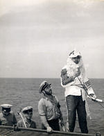 The Ruler of the Raging Main, Neptunus Rex, and his escort arriving on the flight deck of the USS Intrepid for the Line Crossing ceremonies, 22 Jan 1944.