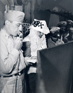 Captain Thomas L Sprague of the USS Intrepid offering remarks of welcome to he Ruler of the Raging Main, Neptunus Rex, and his escort just before for the Line Crossing ceremonies, 22 Jan 1944.