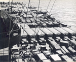 USS Intrepid departing San Francisco, California, 9 Jun 1944 packed with vehicles, equipment, and aircraft including SBD Dauntless, F6F Hellcats, C-45 Expeditors, PV-1 Venturas, and P-61 Black Widows. Photo 3 of 3