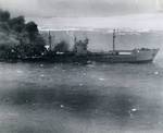 Japanese Type 2AT tanker Otsusan Maru burning and heading for the beach on the coast of French Indochina (Vietnam) north of Qui Nhon after its convoy was attacked by 175 United States Navy carrier planes, Jan 12, 1945.