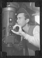 Crewman at the periscope of USS Burrfish, 1943-1945