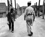 A Japanese prisoner of war bowing to camp commander Lieutenant Harold F. Gannon, Guam, Aug-Sep 1945