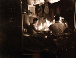 Japanese prisoners of war playing mahjong in candlelight, Guam, Aug-Sep 1945