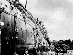 Troops abandoning ship after the converted luxury liner SS President Coolidge struck two mines while entering the harbor at Espiritu Santo, New Hebrides, 26 Oct 1942. Only 2 men were lost out of over 5,000.